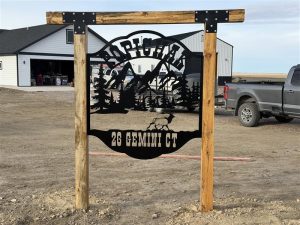 Standing at 26 Gemini Ct, west of the airport in Montana, the Popichak sign is a hand-built blue pine and steel homestead marker — stained with used motor oil , weather-tested, and locally known as the nicest one around.